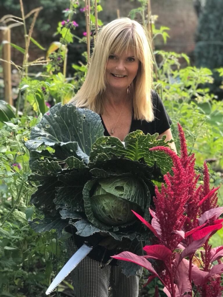 M.Day.ArtistGardener Esher Garden Designer Michaela Day in the vegetable garden.