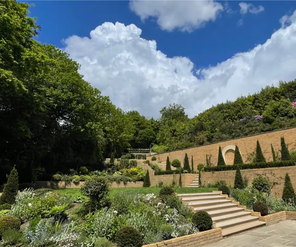 Large bespoke garden planting scheme with retaining walls in Weybridge Surrey.