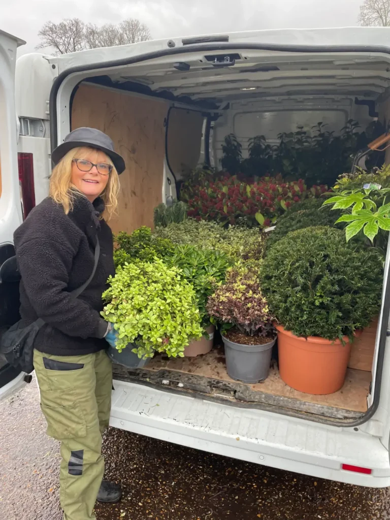 michaela-day-garden-designer-hero Michaela Day Garden Designer receiving a plant delivery from the back of a van.